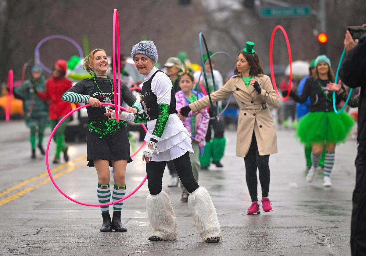 Members of KC Hoop Girl including Amanda Edmonds, left, and Sirenna Beyer hooped in up during the 2023 Brookside St. Patrick’s Day Warm-Up Parade on Saturday March 11, 2023 in Kansas City.