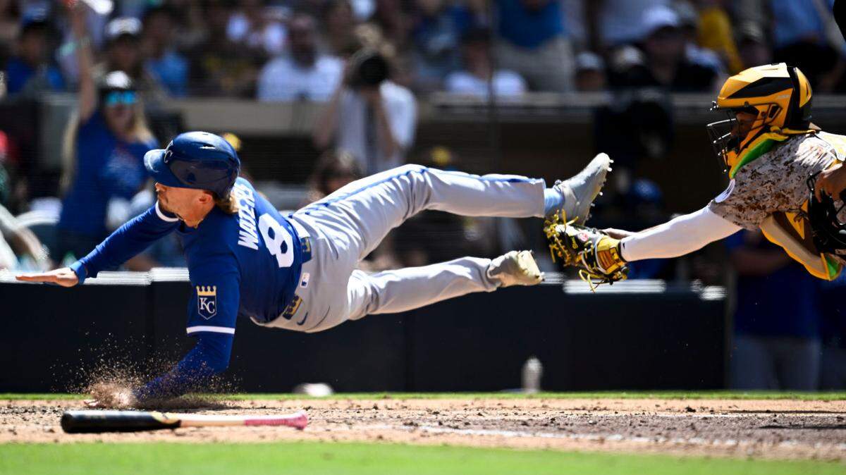 Kansas City Royals outfielder Drew Waters, left, was called out at home plate while trying to score around the tag of Padres catcher Martín Maldonado during the ninth inning of a Sunday, June 22, 2025 Major League Baseball game at Petco Park in San Diego.