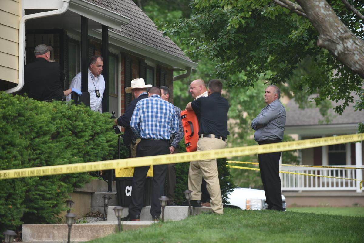 Detectives and crime scene investigators were at the scene of a triple shooting Thursday in the 1200 block of Oakwood Drive in Lee’s Summit that left two dead and a third in serious condition.