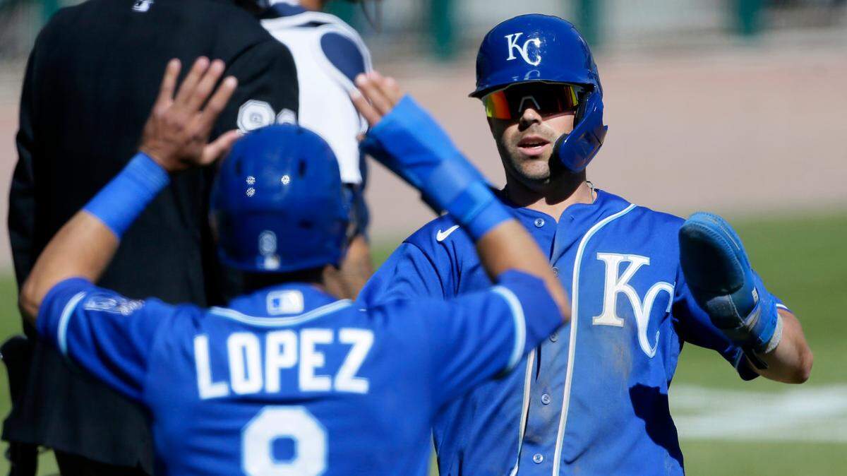 Kansas City Royals’ Whit Merrifield and second baseman Nicky Lopez (8) celebrate after scoring against the Detroit Tigers on a single by Carlos Santana during the ninth inning of a baseball game Sunday, April 25, 2021, in Detroit. (AP Photo/Duane Burleson)
