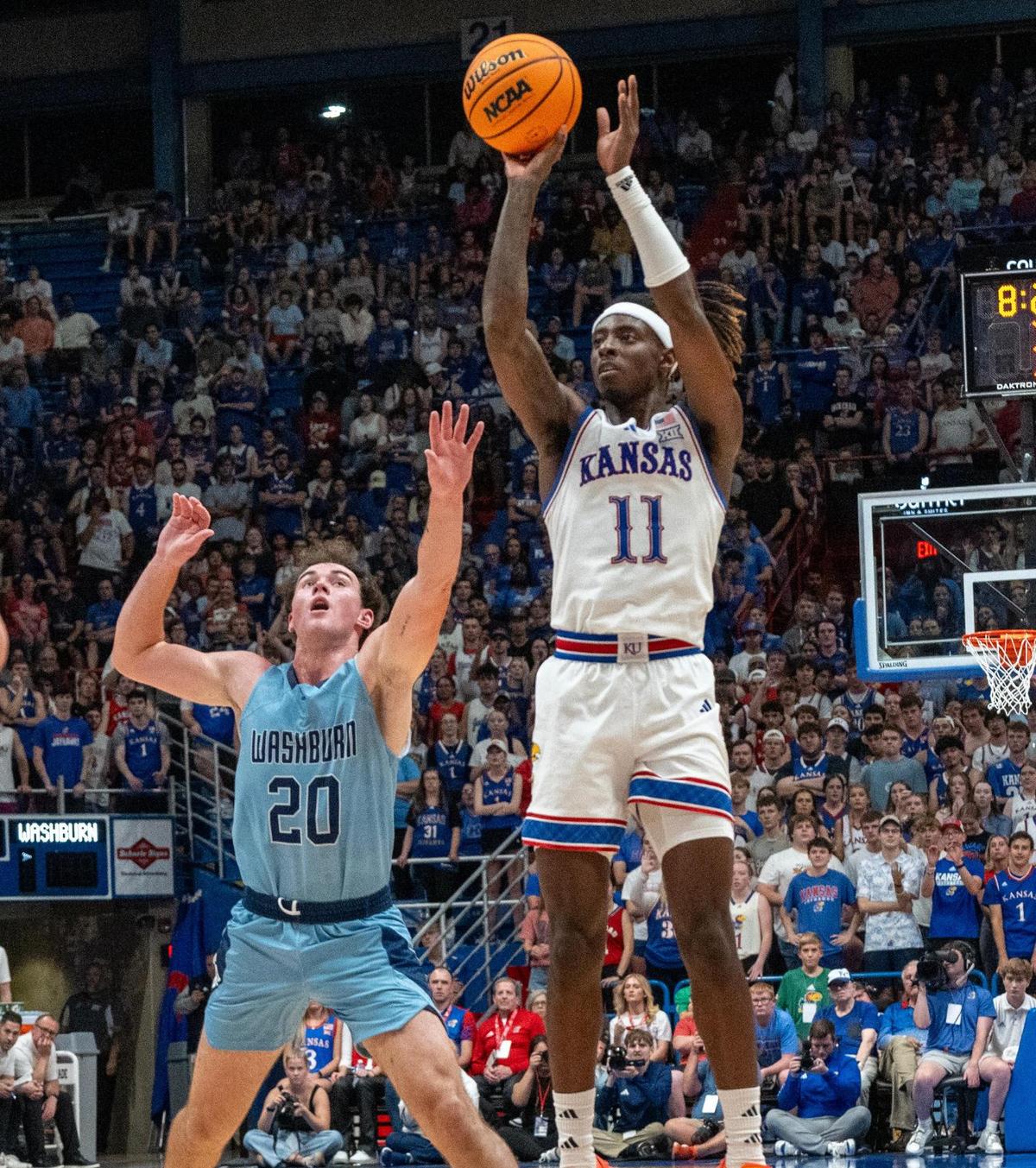 Kansas Jayhawks guard Jamari McDowell (11) shoots against Washburn’s Brayden Shorter in the first half on Tuesday, Oct. 29, 2024, in Allen Fieldhouse in Lawrence.