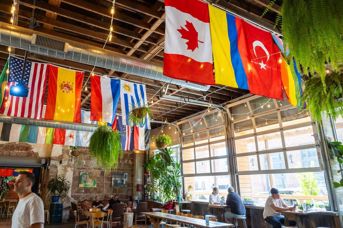 Flag of the 48 nations playing in the 2026 FIFA World Cup hang from the ceiling at the Casual Animal Brewing Co. , 1725 McGee St.