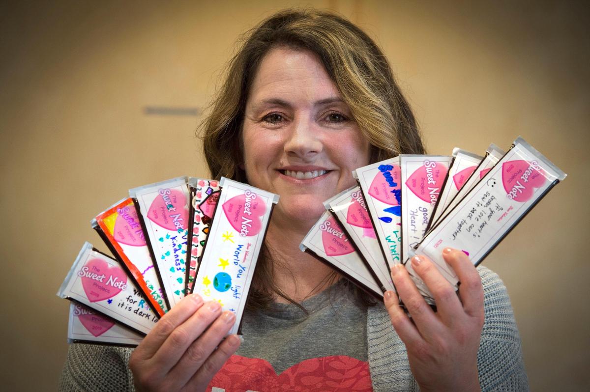 Missy Pint of Lenexa displays created Sweet Notes, chocolate bars adorned with handwritten notes of love and inspiration from Johnson County schoolchildren. She delivered 3,550 of them to Marjory Stoneman Douglas High School in Parkland, Fla.