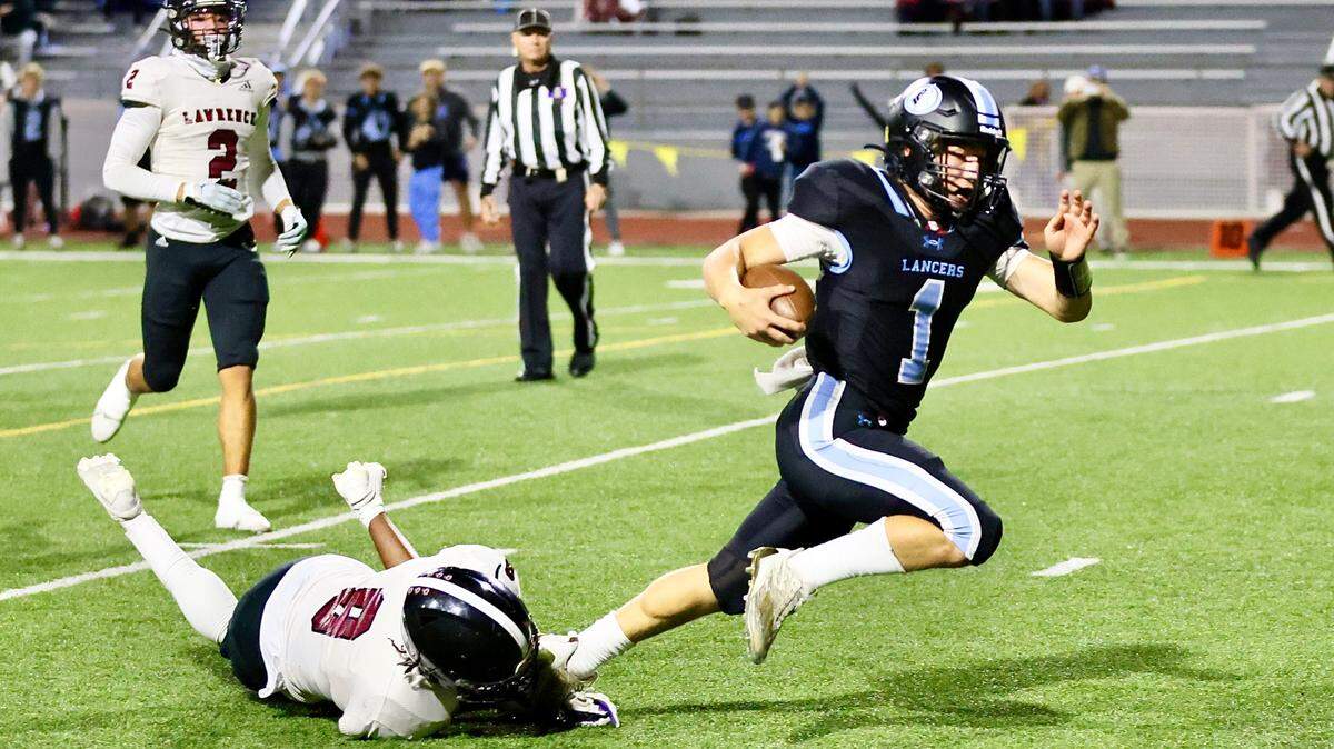 Jack Reeves takes off for one of his two touchdowns Friday night during Shawnee Mission East’s 28-14 win over Lawrence in the Kansas Class 6A state high school football playoffs.