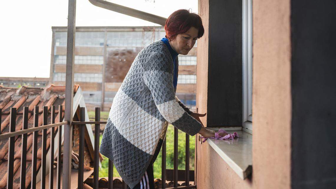 a woman cleaning her patio.