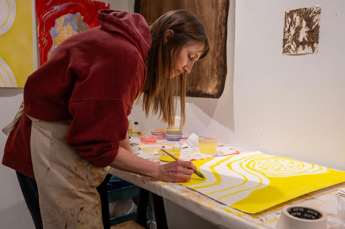 Artist Erin Dodson, a first-year resident, works on a painting inside her studio at Charlotte Street Foundation.
