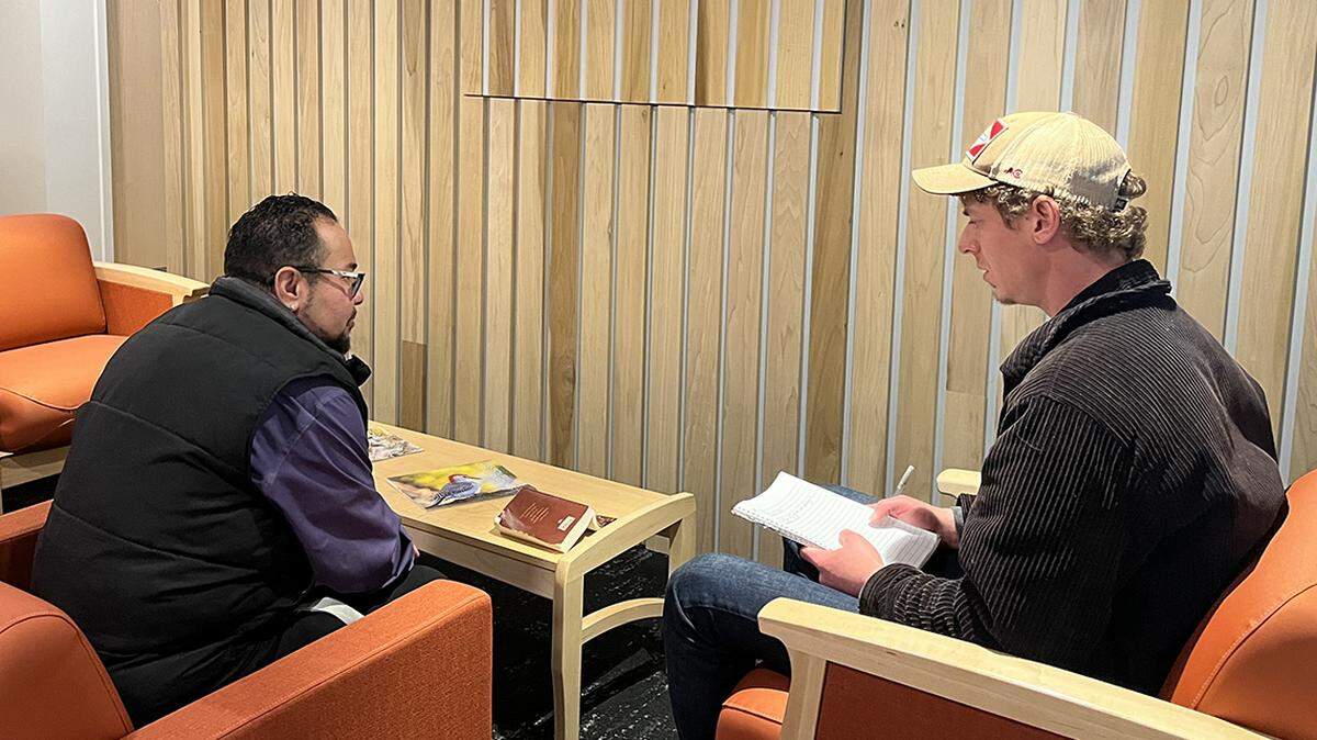Stephan Garcia, guest services manager at Shelter KC, speaks to John, who is part of the Renew Mental Health program.