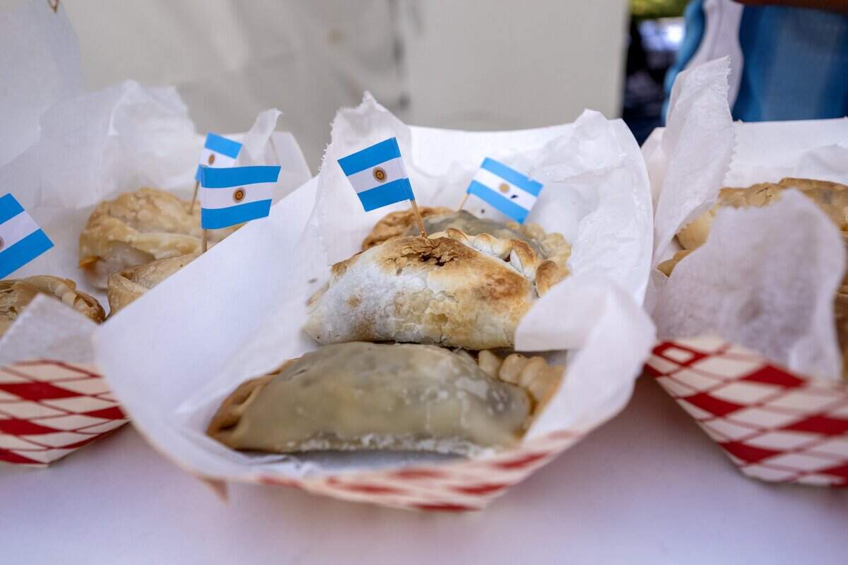 Empanadas from Argentina Inc. Empanadas are served with an Argentine flag at the FIFA Fan Festival on Sunday, June 14, 2026, in Kansas City.