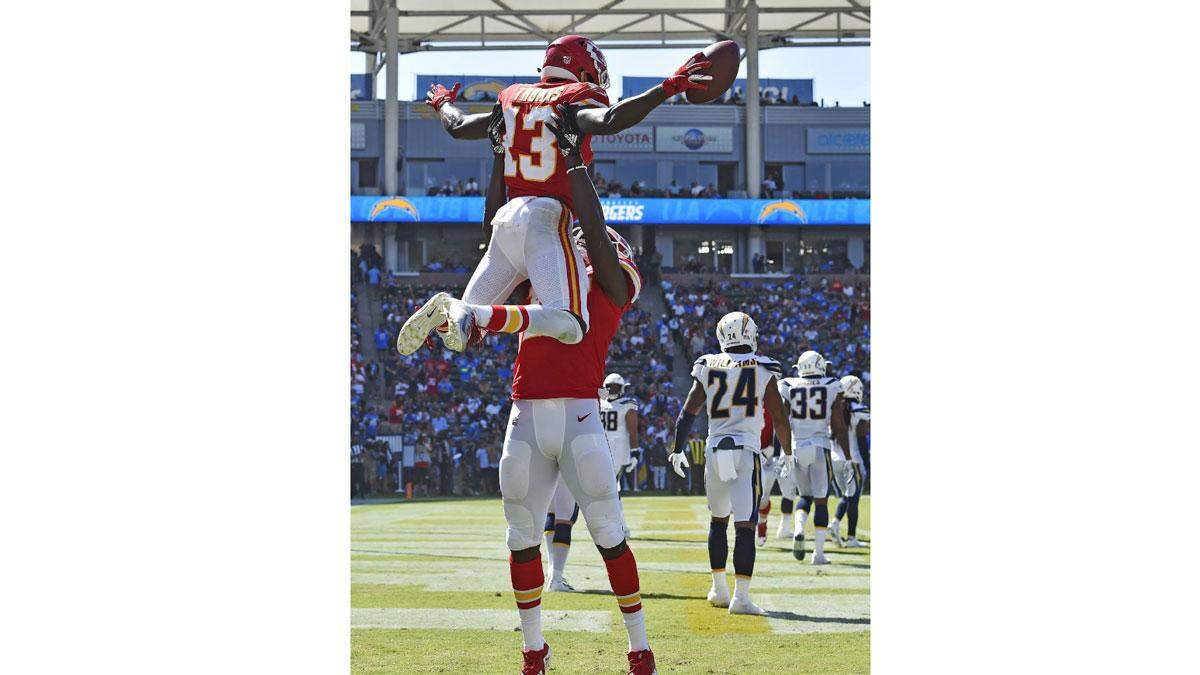 Kansas City Chiefs wide receiver De’Anthony Thomas (13) was hoisted into the air by wide receiver Chris Conley after Thomas scored on a 1-yard shovel pass from quarterback Patrick Mahomes in the third quarter against the Chargers. It was Mahomes’ second touchdown pass of the 2018 season.