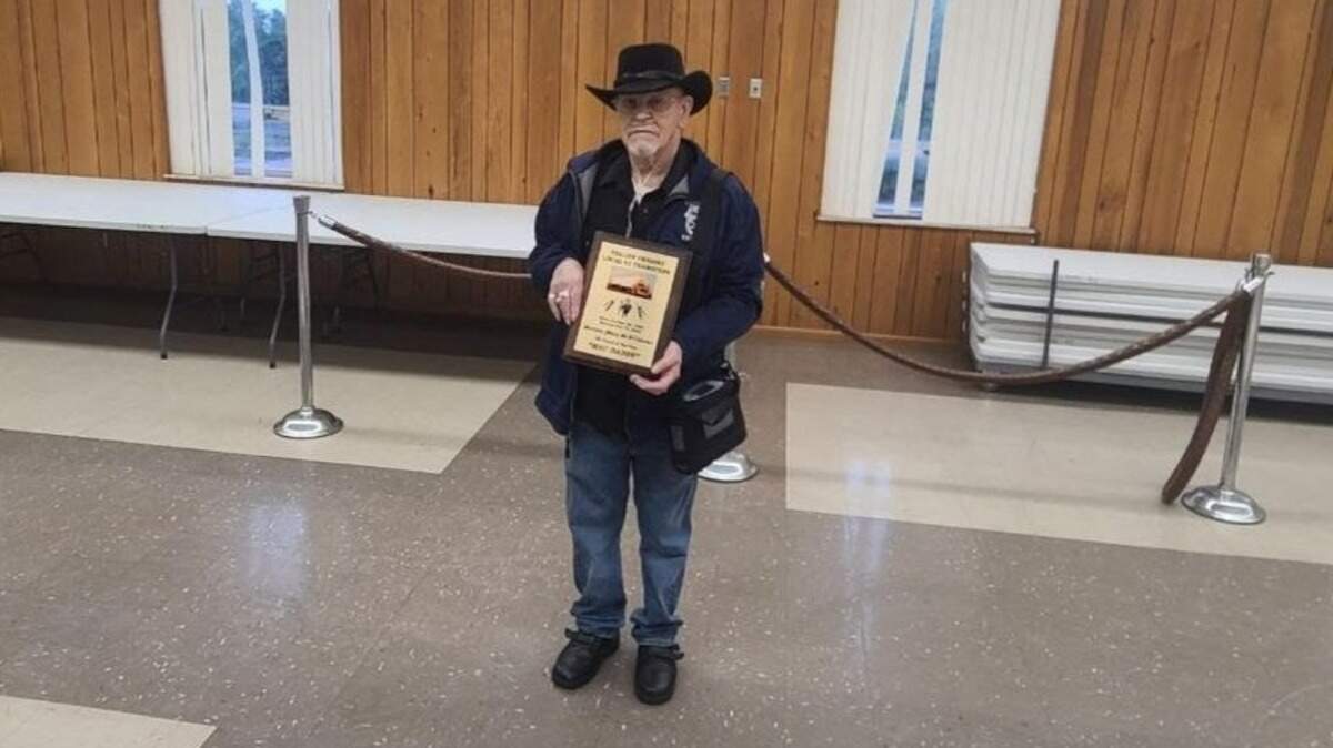 Marion “Mac” McWilliams holds a plaque Monday commemorating his 58 years of service at Yellow Corp.