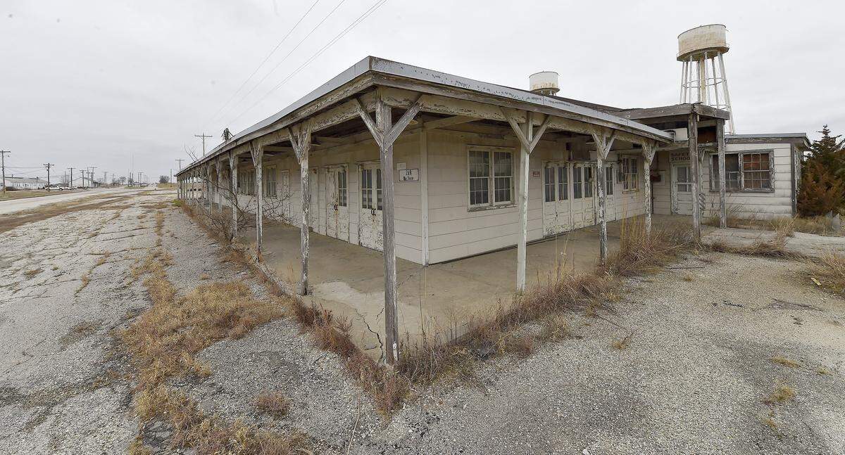 The bus station, where employees would catch rides home after work, still stands below water towers at the former Sunflower Army Ammunition Plant.