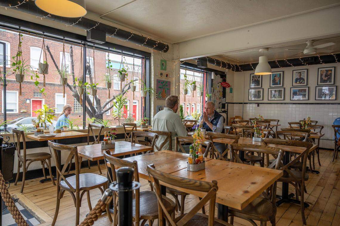 Happy Gillis has a homey vibe, with wooden furniture and plants hanging all over the windows.