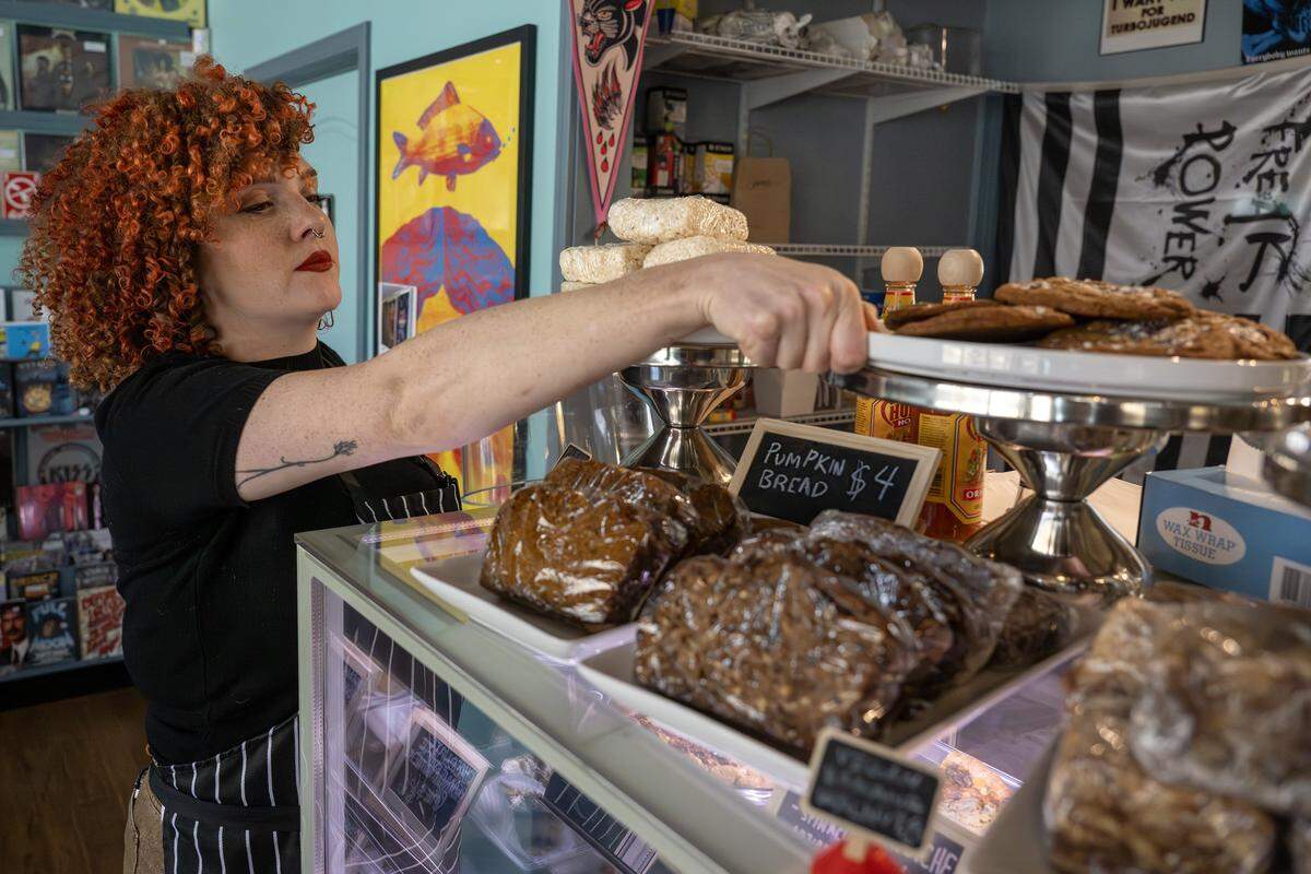 Pastry chef Nichole Taylor organizes baked goods near a display case at Sister Anne's Coffee & Records on Thursday, Dec. 4, 2025, in Kansas City.