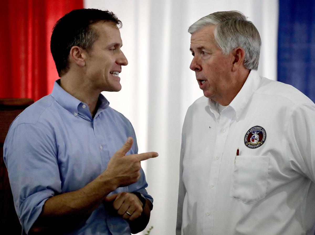 Missouri's 56th governor, Eric Greitens, talked with the man who would become No. 57, Mike Parson, during the Governor's Ham Breakfast at the Missouri State Fair in Sedalia in August 2017.
