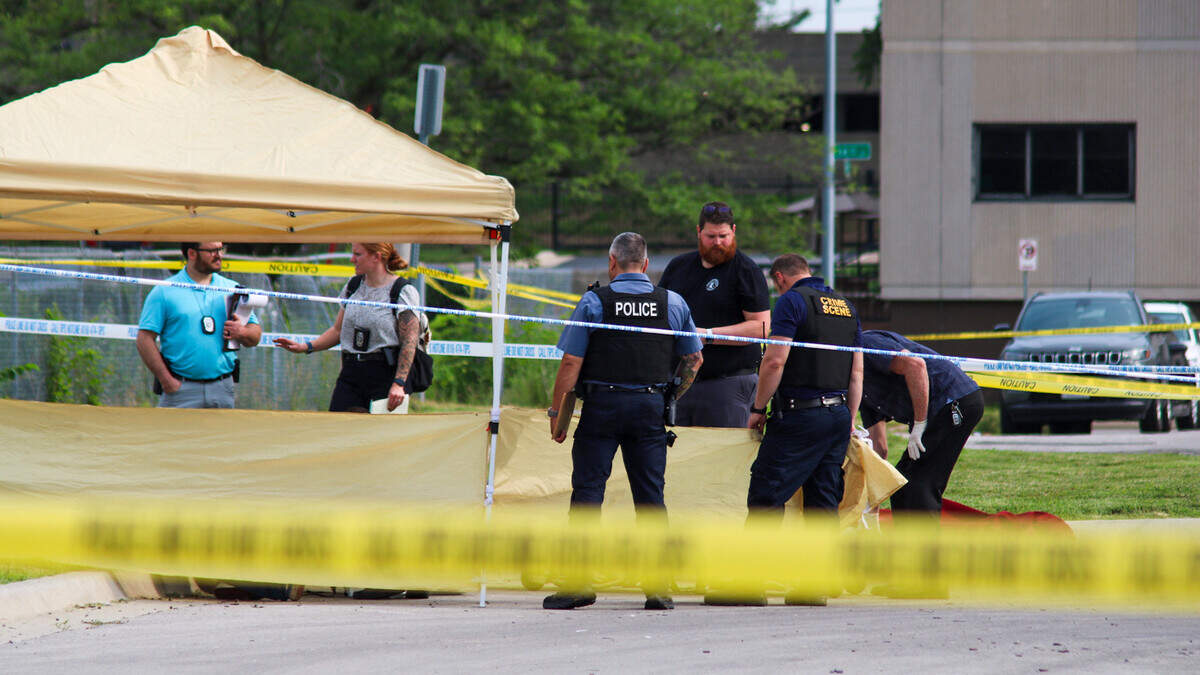 Kansas City Police Department homicide detectives review the scene where a man was found dead in the parking lot of an apartment building June 12, 2025. The man’s official cause of death was under investigation, but police ruled the death a homicide.