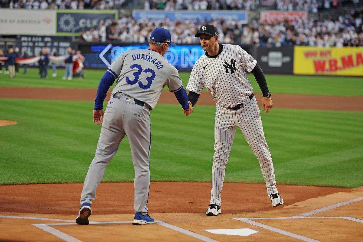 Kansas City Royals manager Matt Quatraro (33) and New York Yankees manager Aaron Boone (17) shake hands before Game 1 of the ALDS at Yankee Stadium on Oct. 5, 2024.