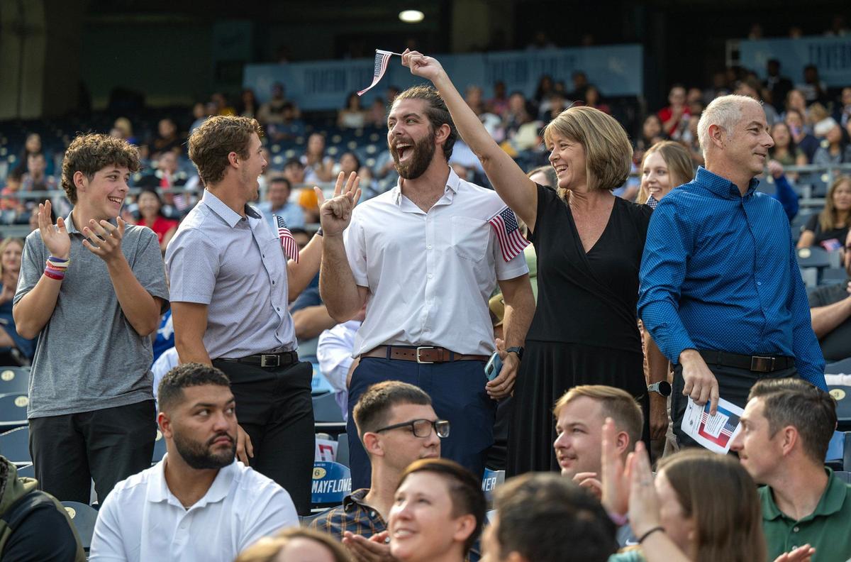 The Kind family, originally from South Africa, celebrated together after becoming American citizens during a naturalization ceremony Thursday at Kauffman Stadium. From left, brothers Benjamin, Joshua, and Nathan Kind, along with their parents Diane and Neil Kind, took the Oath of Allegiance during the event.