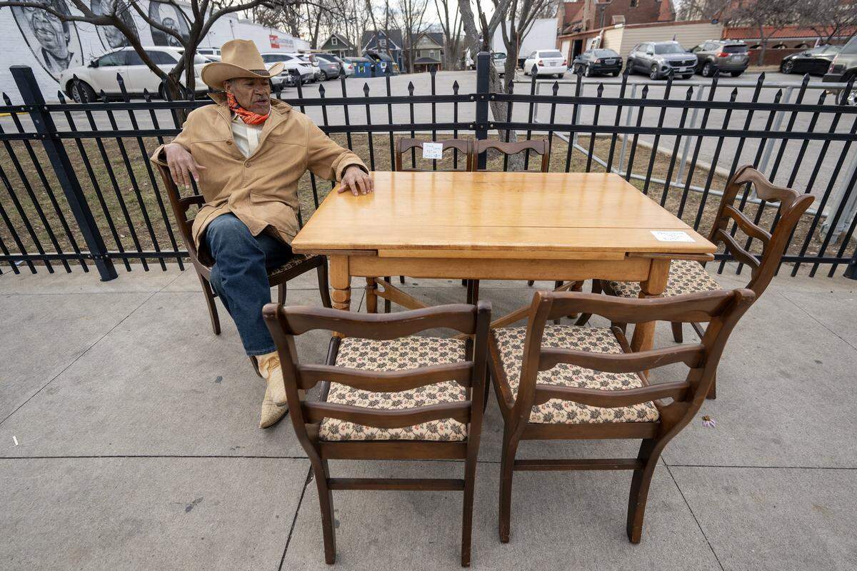 Anthony Stewart takes a seat and looks over a table, $30, and six chairs for sale for $6 each or a the set of six for $30 outside of Troost39 Thrift Store, 3922 Troost Ave., on Thursday, Jan. 15 2026, in Kansas City. Stewart, who lives next door to the shop, said shops at the store twice a week.