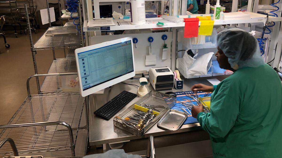 An employee with the sterile processing department at Saint Luke’s Hospital of Kansas City inspects instruments as they are cleaned before being used in operating rooms on Tuesday, Oct. 17, 2023.