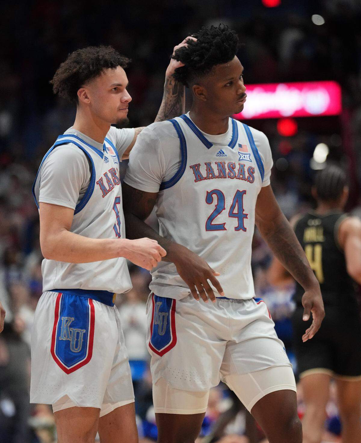 Kansas Jayhawks guard Zeke Mayo (5) celebrates with forward KJ Adams (24) during a timeout against the UCF Knights at Allen Fieldhouse on Jan. 28, 2025.