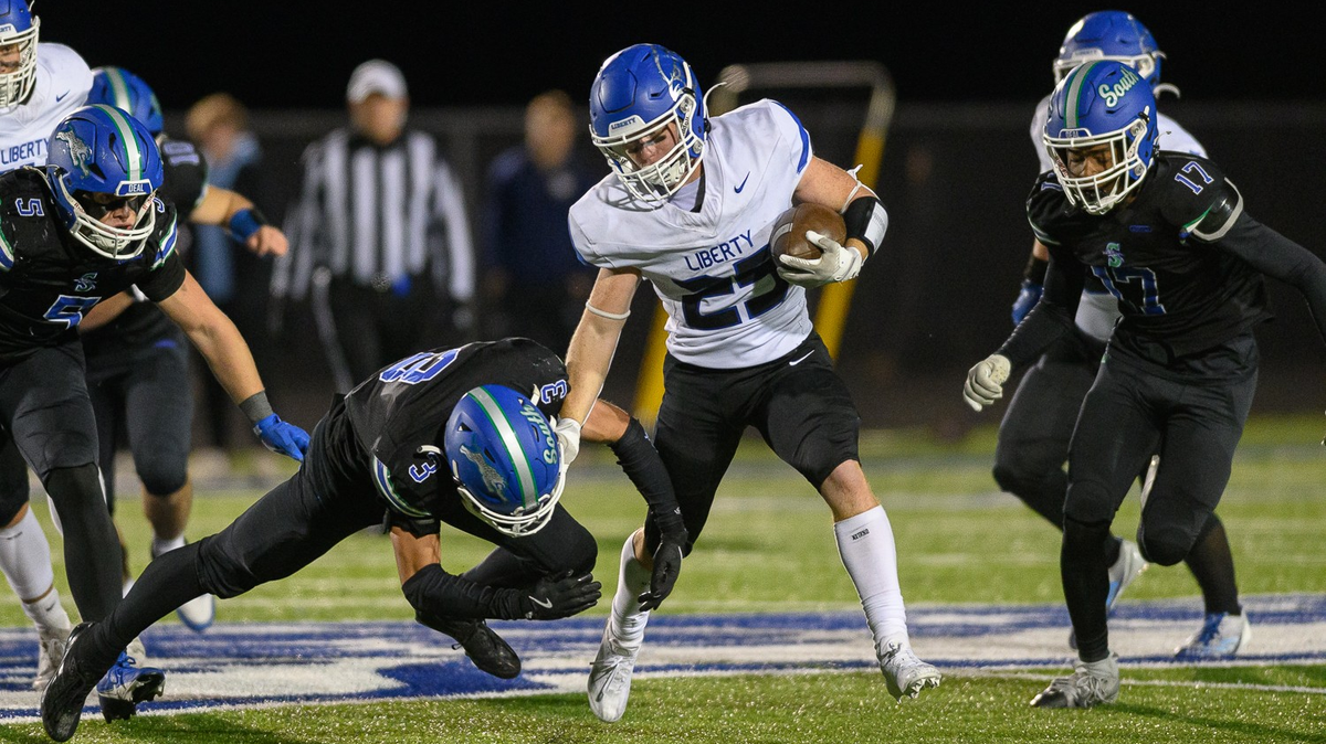 Liberty’s Jaxon Hicks fends off a Blue Springs South defender en route to some of his 280 rushing yards in the Blue Jays’ 28-7 win in the Missouri high school football playoffs on Friday, Nov. 15, 2024.