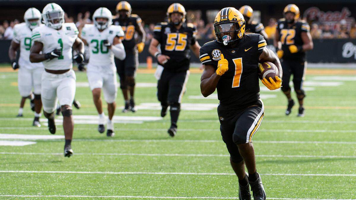 Missouri running back Tyler Badie, front right, outruns the pack as he scores a touchdown during the second quarter of an NCAA college football game against North Texas, Saturday, Oct. 9, 2021, in Columbia, Mo. (AP Photo/L.G. Patterson)