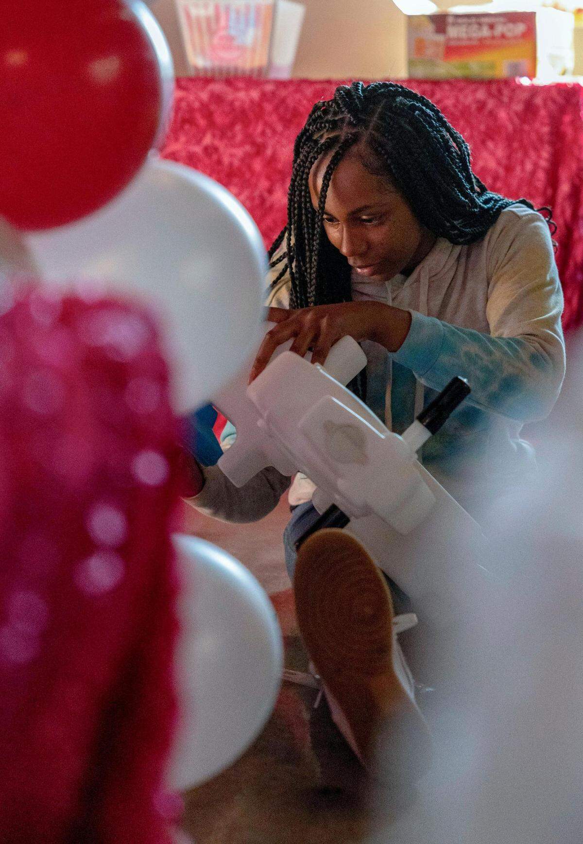 Diamond Fuse, owner of Bizzy Babies, sets up her bounce house play area for a birthday party.