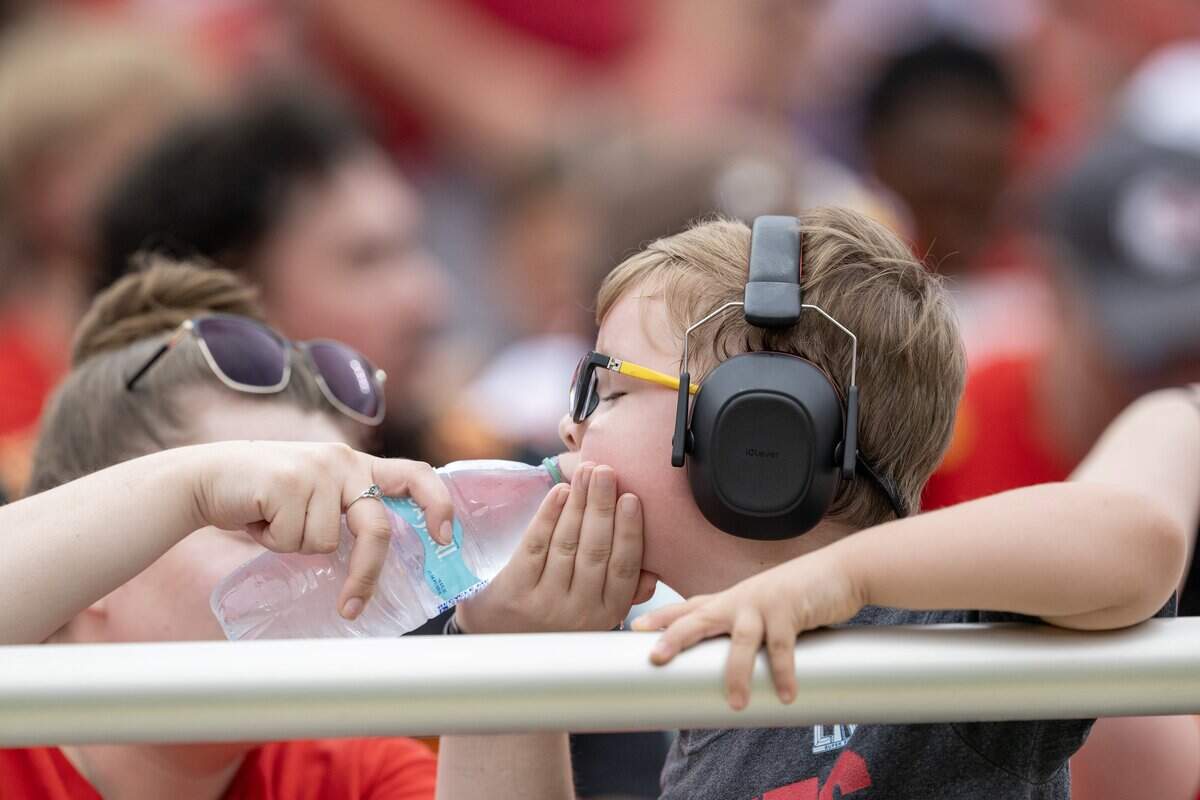 A young fan stays hydrated during a preseason NFL game between Kansas City Chiefs and Los Angeles Rams at Arrowhead Stadium on Saturday, Aug. 15, 2026, in Kansas City.