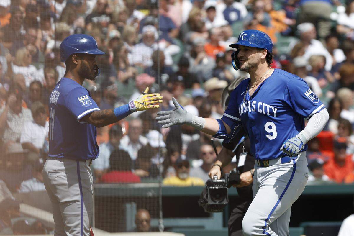 Royals third baseman Maikel Garcia, left, and first baseman Vinnie Pasquantino high-five during a game against the Tigers at Comerica Park in Detroit on Sunday, Aug. 24, 2025.