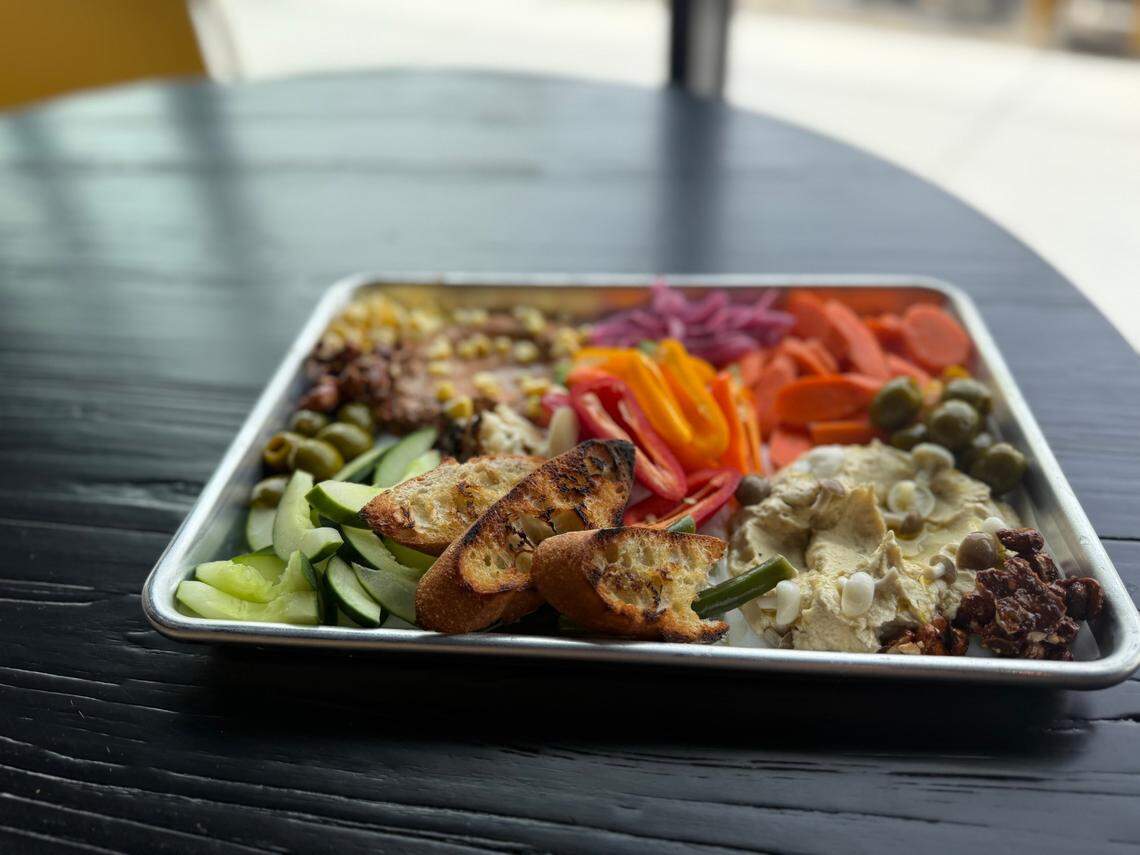 The Mezze Platter has hummus, house pickles, sweet peppers, marinated olives and crudite.