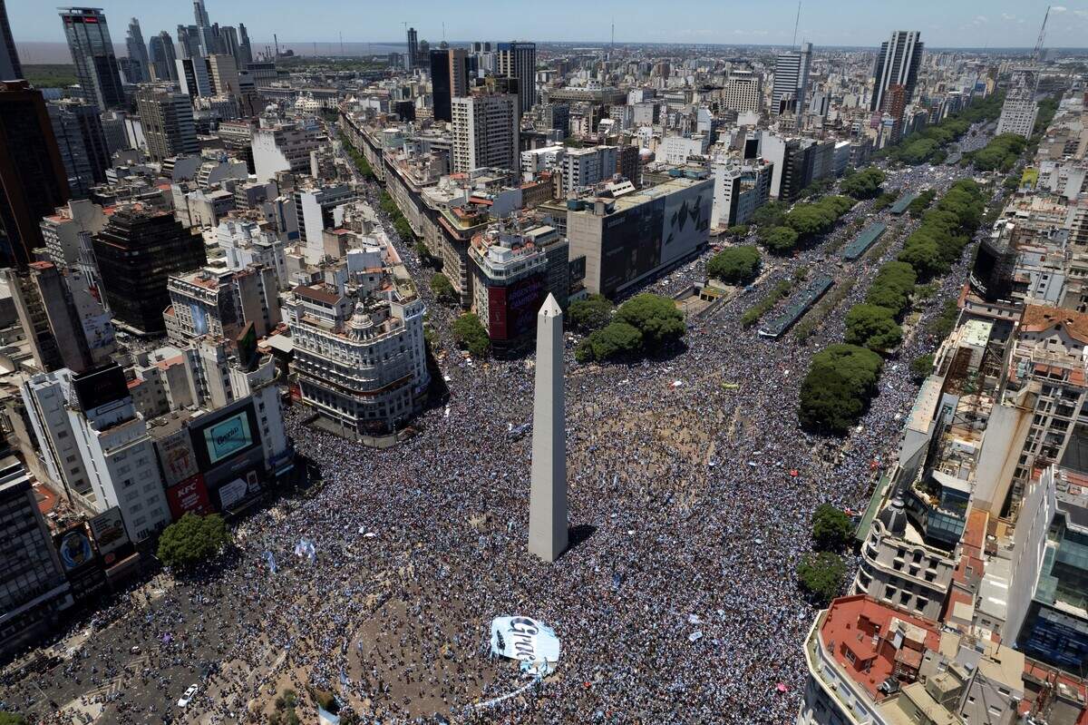 An aerial view of fans of Argentina waiting for the bus with Argentina’s players to pass through the Obelisk to celebrate after winning the Qatar 2022 World Cup tournament in Buenos Aires on December 20, 2022.