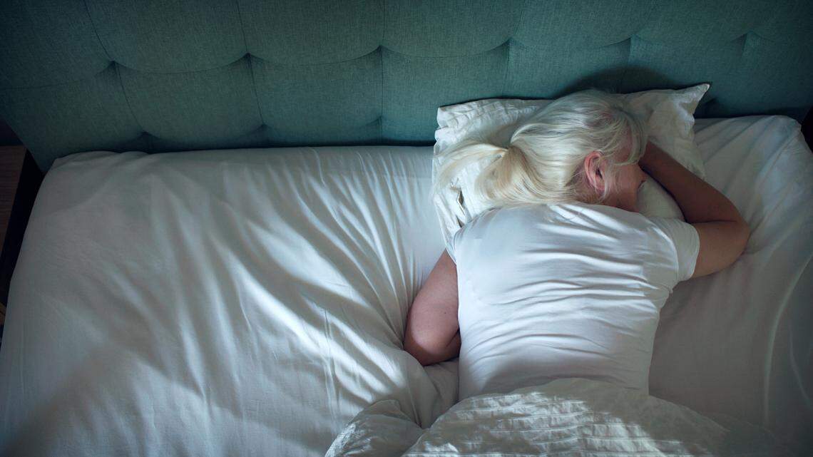 woman asleep in bed seen from above photo illustration