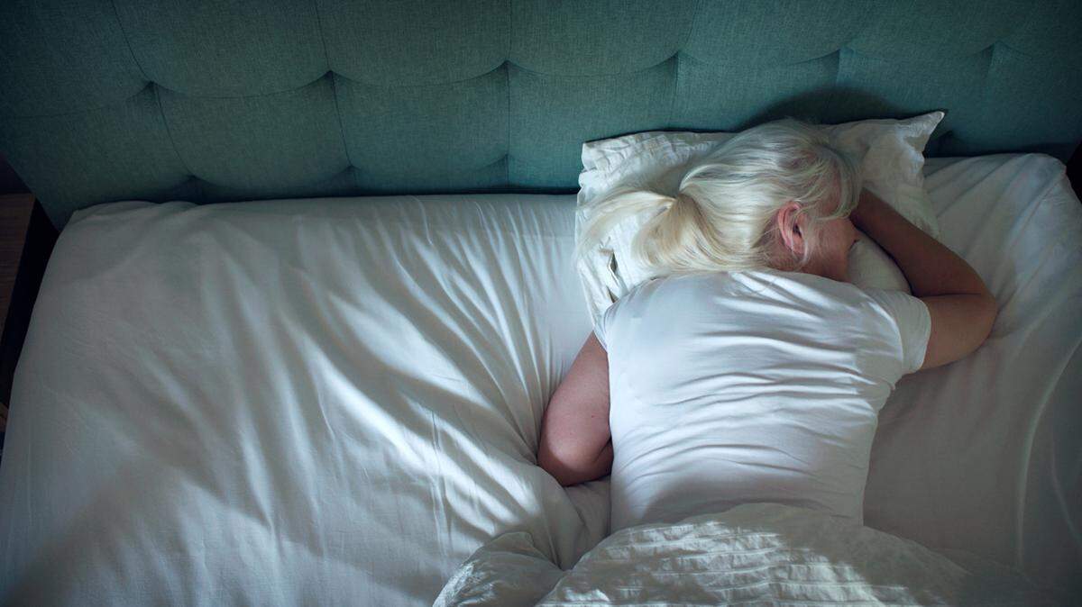 woman asleep in bed seen from above photo illustration