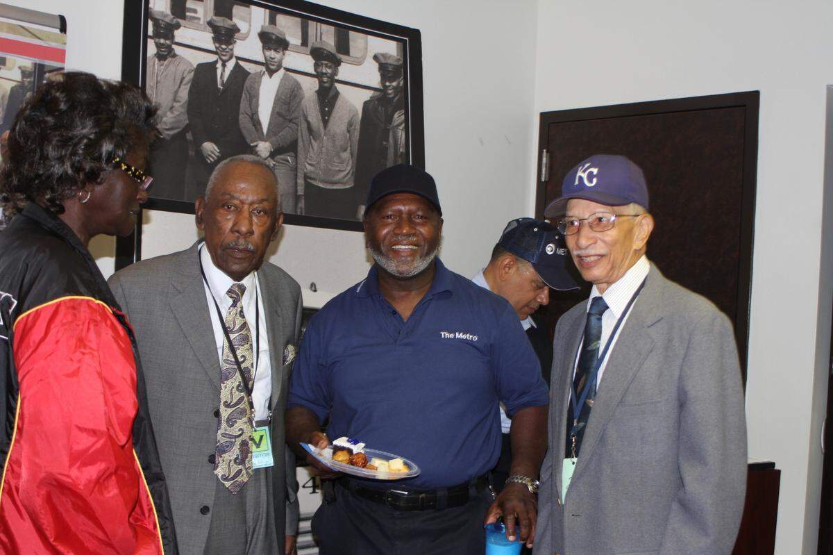 Nick Green (right) with friends from the transit authority during a 90th birthday celebration for Harris (left), one of the first five Black bus drivers to work for the department.