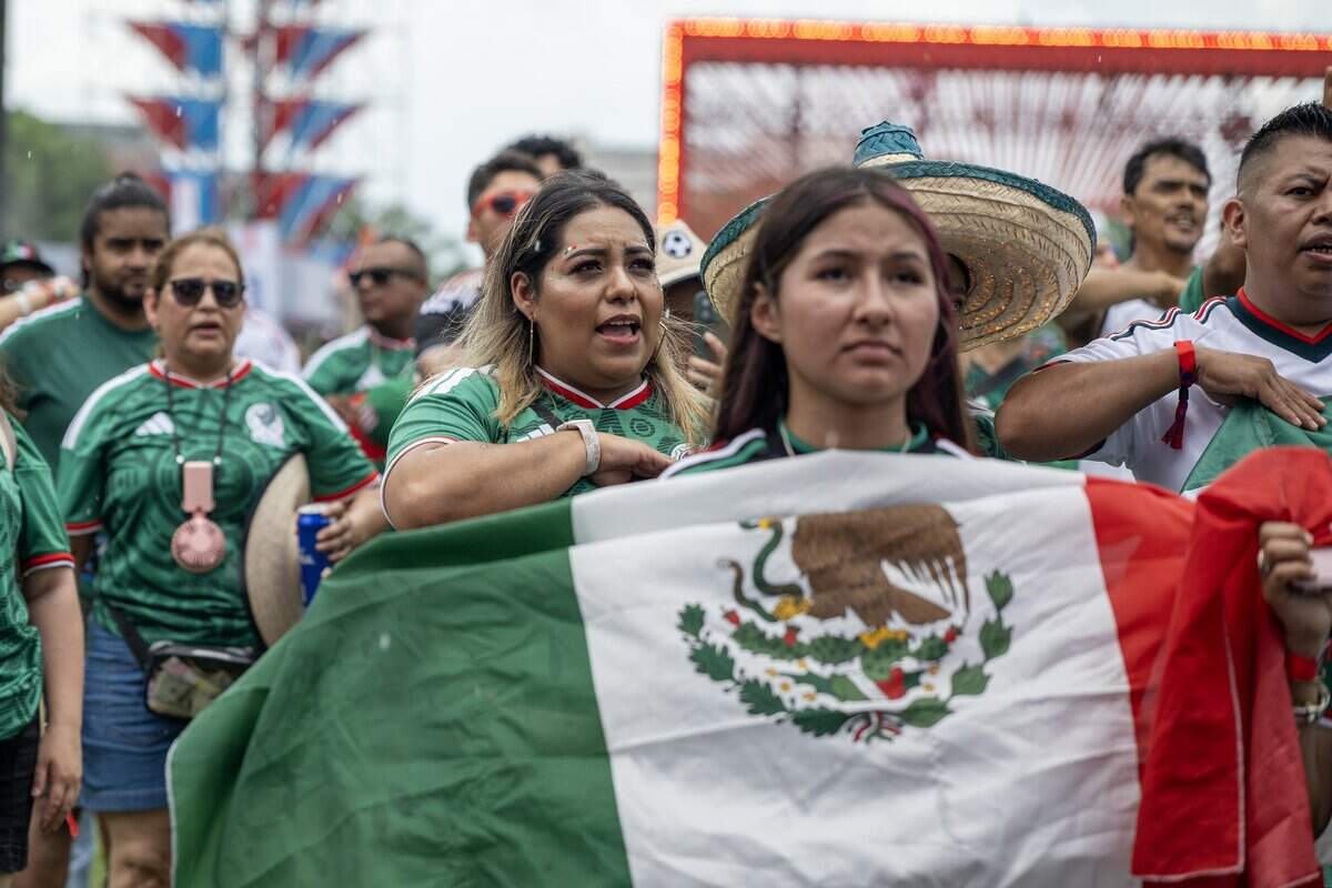 Mexico fans sing the Mexican national anthem before watching a FIFA World Cup match between Mexico and South Africa at the FIFA Fan Festival on Thursday, June 11, 2026, in Kansas City.