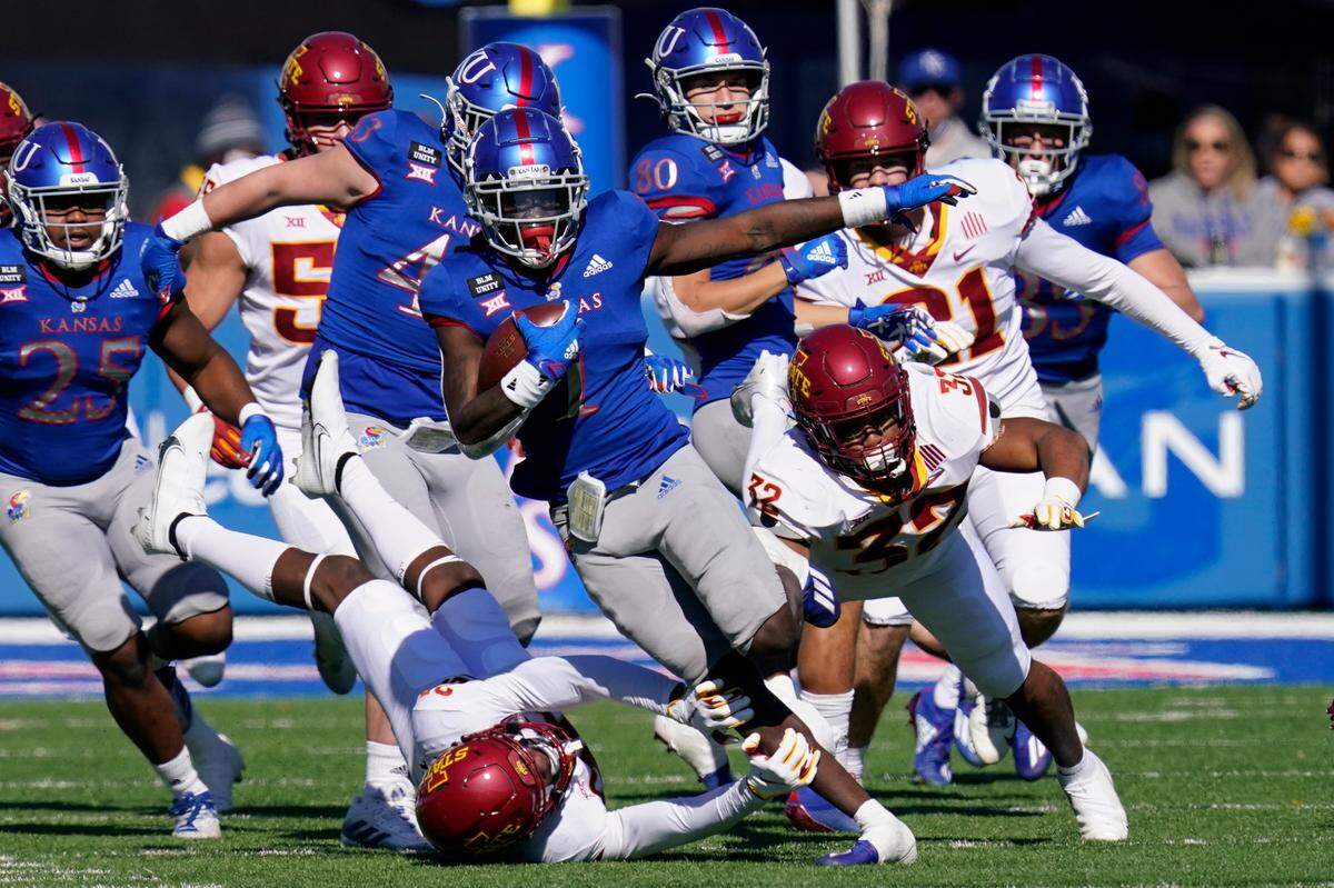 Kansas return specialist Kenny Logan Jr. (1) breaks away from Iowa State defenders Gerry Vaughn (32) and Vonzell Kelley III (29) for a 100-yard touchdown kickoff return during the second half of an NCAA college football game in Lawrence, Kan., Saturday, Oct. 31, 2020. (AP Photo/Orlin Wagner)