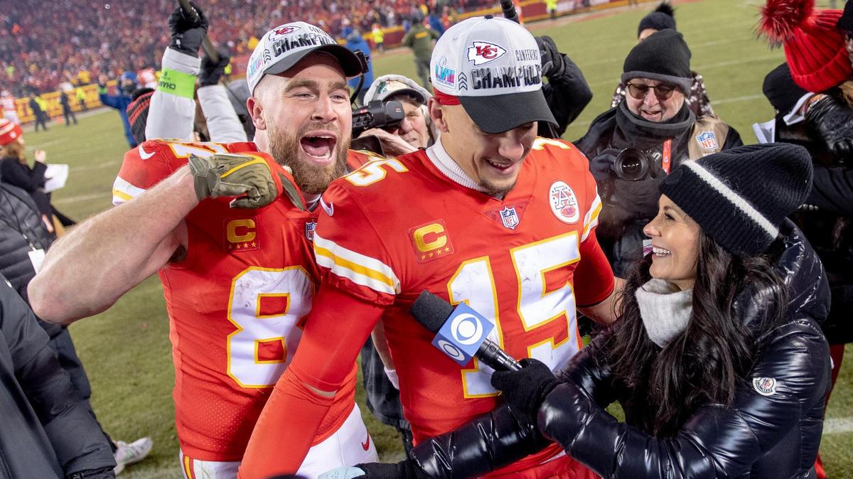 Kansas City Chiefs tight end Travis Kelce (87) interrupts an interview to celebrate with quarterback Patrick Mahomes (15) after the Chiefs defeated the Cincinnati Bengals 23-20 in the AFC Championship NFL football game at GEHA Field at Arrowhead Stadium on Sunday, Jan. 29, 2023, in Kansas City.