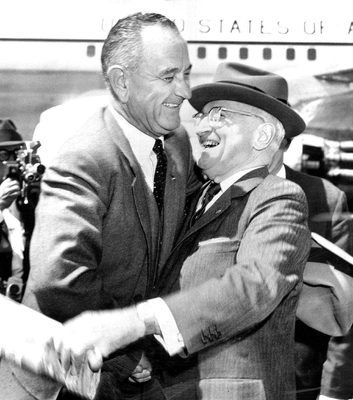 Vice President Lyndon B. Johnson hugs former President Harry S. Truman upon arriving in Kansas City in April 1961 for a luncheon. Johnson came to brief Truman on the Cuban crisis and visit his longtime friend and mentor.