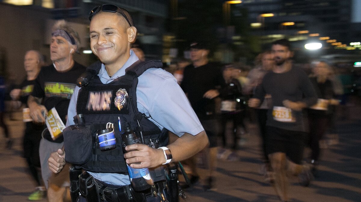 Kansas City, Kan., police officer Carlos Mena, 30, wore 30 pounds of police gear to run 26.2 miles in the Kansas City Marathon Saturday, Oct. 20. Mena wore the gear in honor of officers who died in the line of duty.