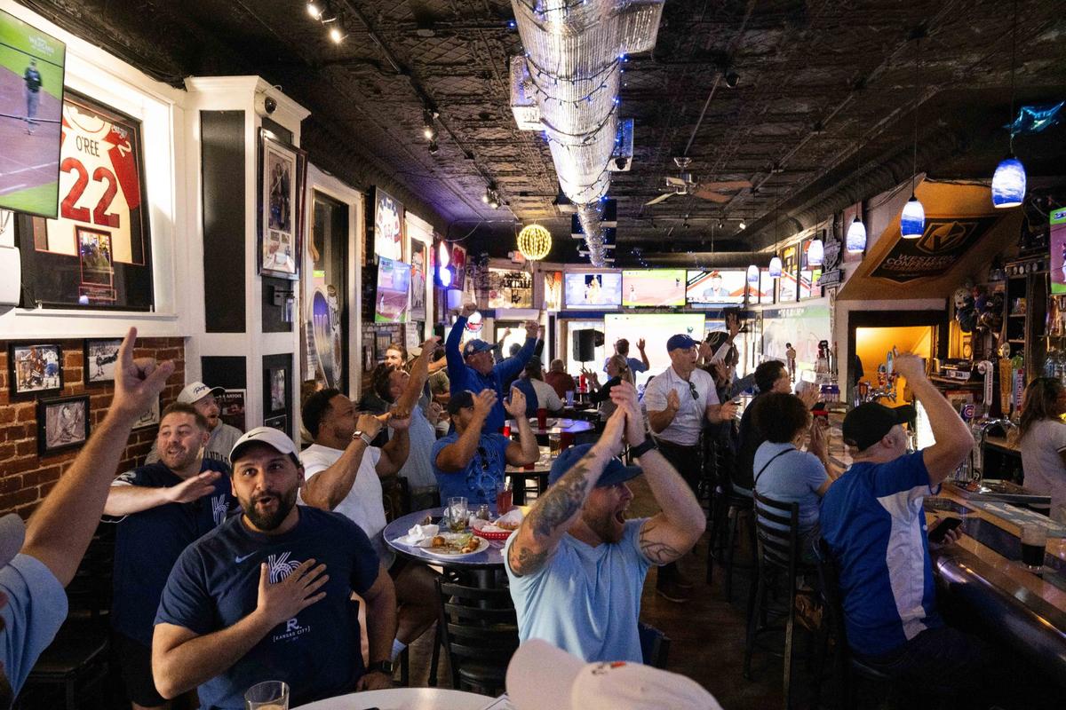Fans cheer on the Royals vs. the Baltimore Orioles at the Blue Line in the River Market on Wednesday, Oct. 2. The Royals won the game 2-1 and advanced to play the New York Yankees.