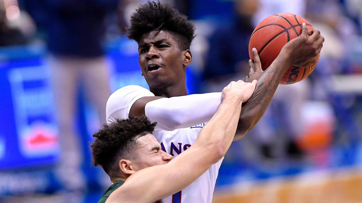 KU’s Tyon Grant-Foster is fouled hard by North Dakota State’s Jarius Cook while driving to the bucket on a fastbreak in a game at Allen Fieldhouse.