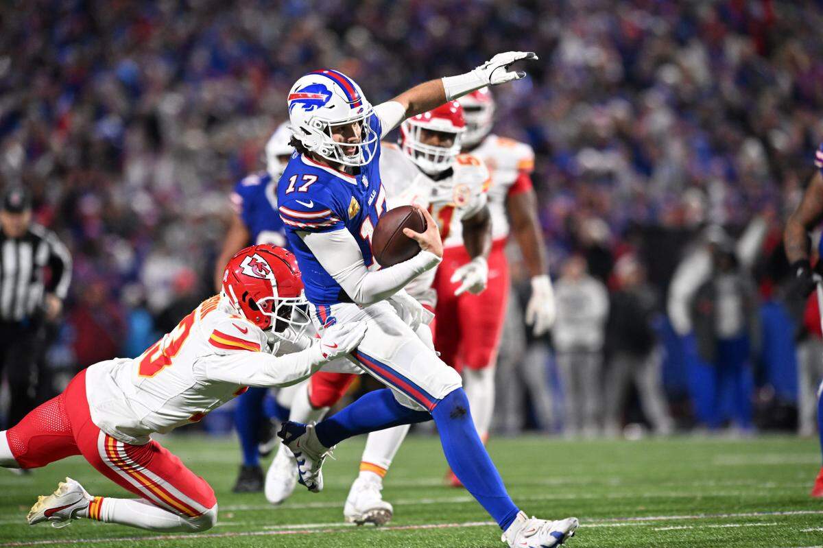 Buffalo Bills quarterback Josh Allen breaks a would-be tackle by Kansas City Chiefs safety Nazeeh Johnson en route to the end zone late in a Sunday, Nov. 17, 2024 NFL Week 11 game at Highmark Stadium in Orchard Park, New York.