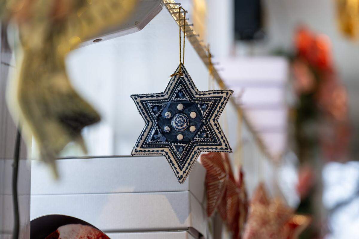 A ceramic star ornament crafted by artist Irma Starr hangs from a hook in her home studio on Thursday, Dec. 11, 2025, in Kansas City.