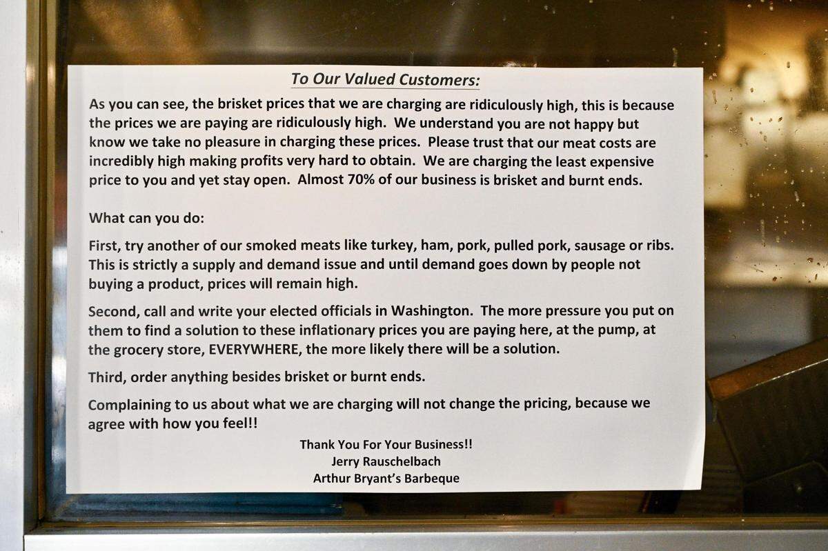 A sign at Arthur Bryant’s Barbeque restaurant explains to customers that they are charging “ridiculously high” prices for brisket and burnt ends because they are paying ridiculously high prices for the beef.