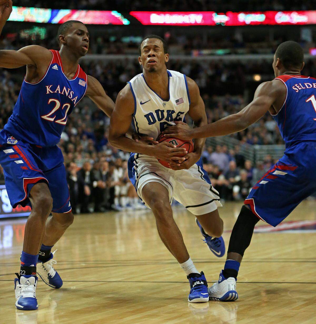 Rodney Hood #5 of the Duke Blue Devils moves between Andrew Wiggins #22 and Wayne Selden Jr. #1 of the Kansas Jayhawks during the State Farm Champions Classic at the United Center on November 12, 2013 in Chicago.