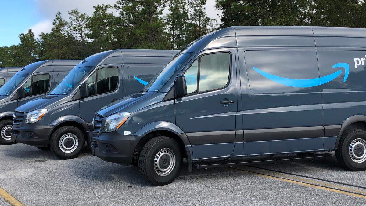 Amazon delivery trucks in a line.