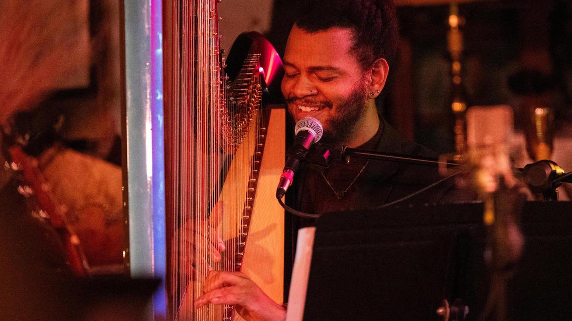 Calvin Arsenia, singer, song-writer and musician performs at a show for the Greenwood Social Hall in Kansas City playing the harp.