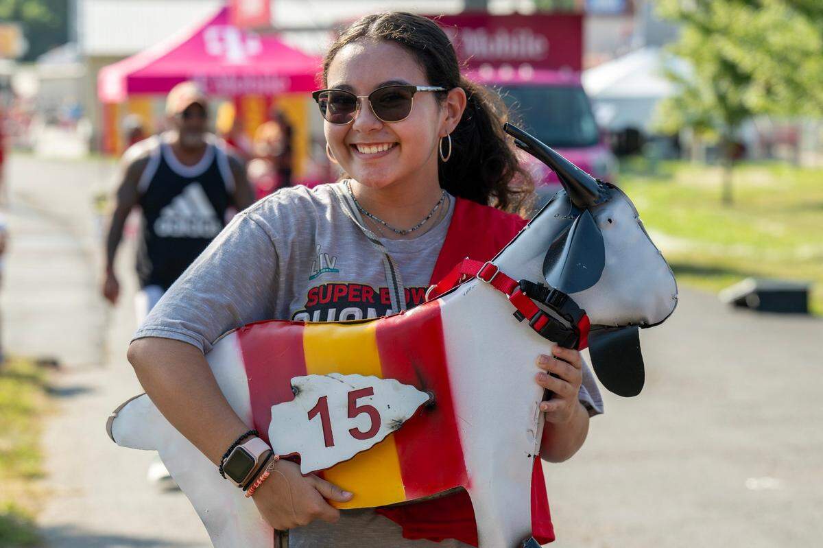 Thirteen-year-old Eva Ippolito holds a Kansas City Chiefs-themed goat at training camp. Ippolito’s grandfather bought the goat to hopefully get it signed by quarterback Patrick Mahomes.