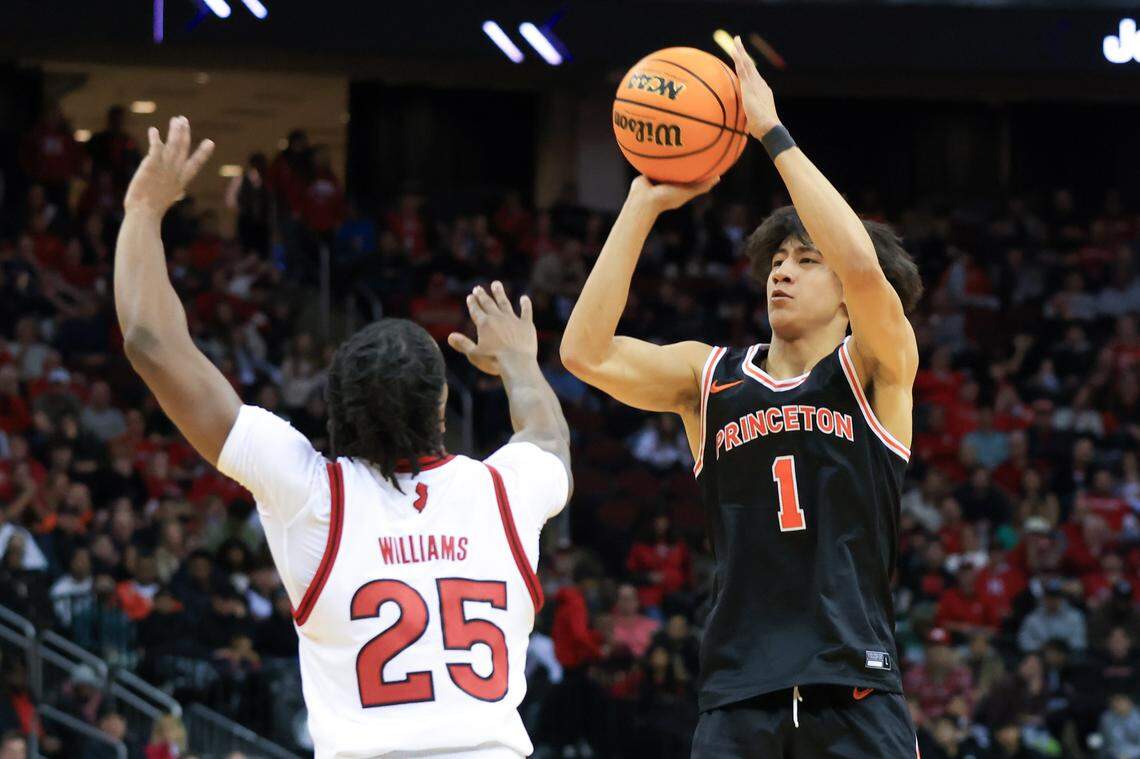 Princeton Tigers guard Xaivian Lee (1) shoots a 3-point basket while being guarded by Rutgers Scarlet Knights guard Jeremiah Williams (25) during the second half at Prudential Center on Dec. 21, 2024.