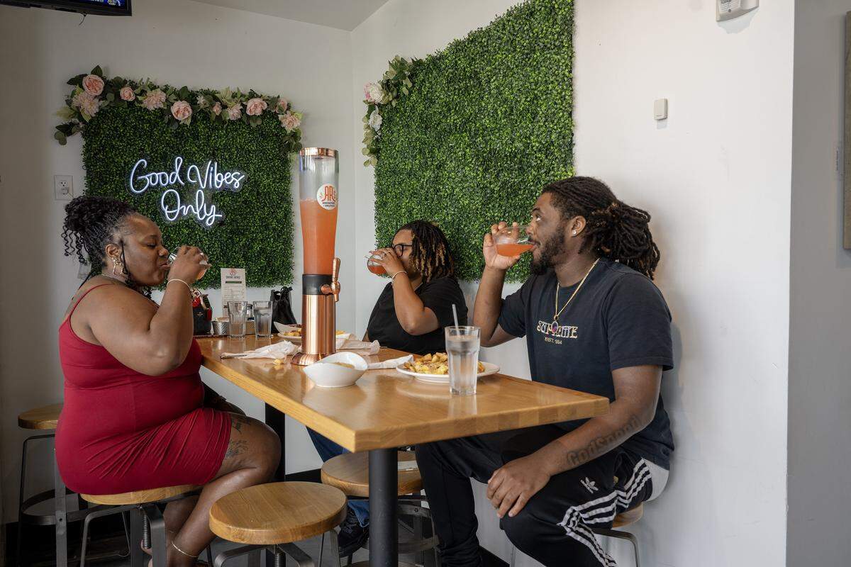 It was Mimosa time for Fantasya Tucker, from left, of Omaha, Aryon Tate of Kansas City, and Robert Nicholson of St. Louis, who ordered a strawberry pineapple Mimosa tower on Tuesday, August 19, 2025, at AR's Breakfast and Brunch, 8021 Metcalf Ave., in Overland Park.